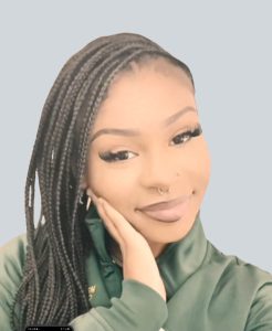 Eryka "Tommy" Neal, professional natural hair specialist at Nappy Hutt LLC, in a professional headshot.